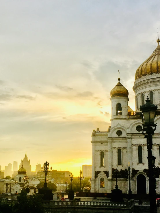 a large white building with a golden dome, inspired by Vasily Surikov, pexels contest winner, socialist realism, vista of a city at sunset, with great domes and arches, 000 — википедия, square