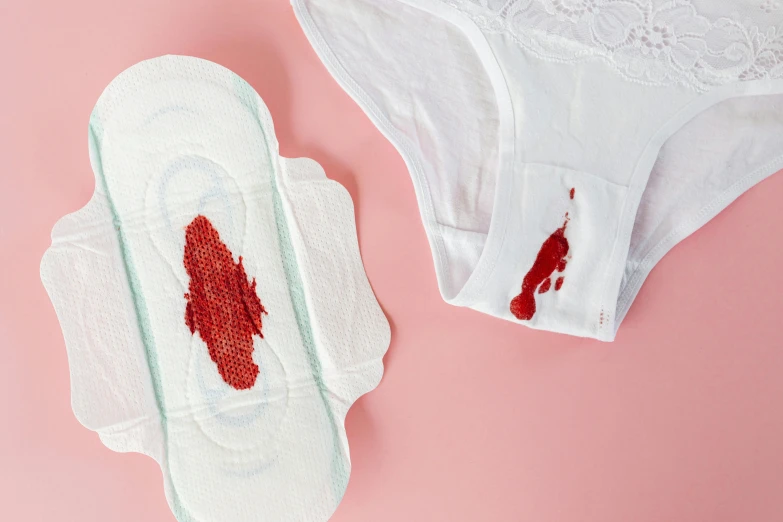 a pair of sanitary pads with blood on them, by Julia Pishtar, trending on pexels, silicone patch design, from the waist up, payne's grey and venetian red, violence blood