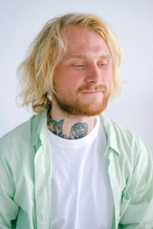 a man with a tattoo on his neck, by Lasar Segall, trending on unsplash, pale skin curly blond hair, wearing a light shirt, soft shade, artist wearing dirty