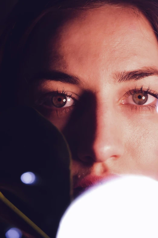 a close up of a person holding a cell phone, stars in her gazing eyes, emerging from her lamp, microscopy, rey