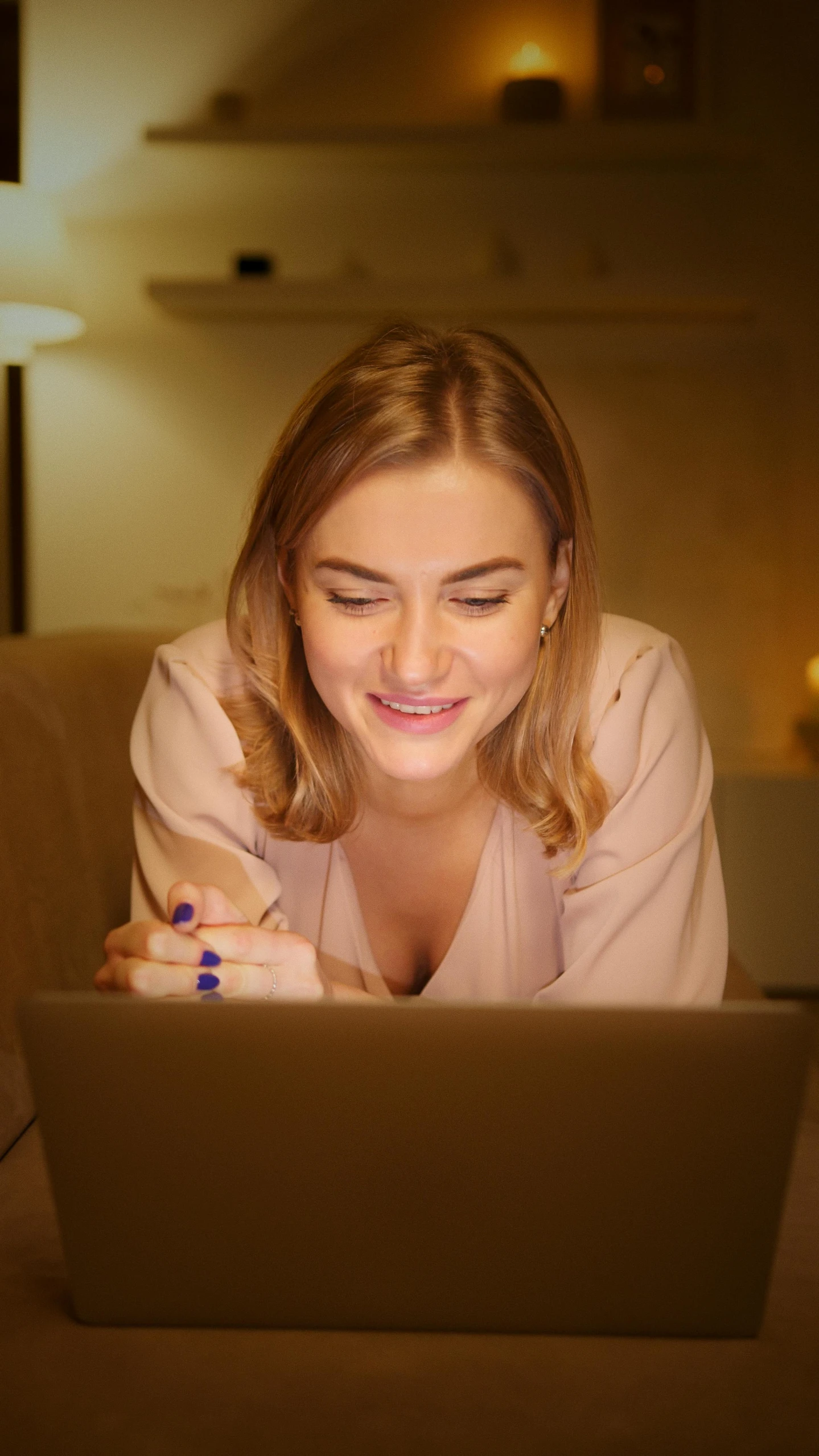 a woman laying on a couch looking at a laptop, a portrait, pexels, soft lights, a still of a happy, a blond, thumbnail