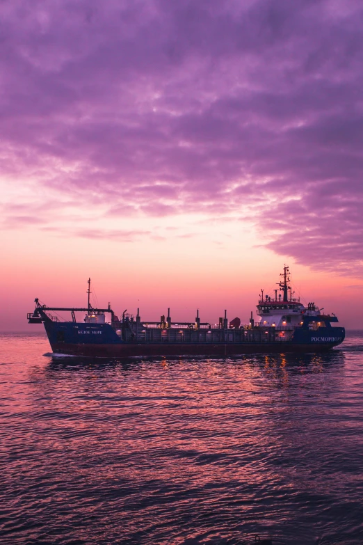 a large boat floating on top of a body of water, by Joseph Severn, pexels contest winner, purple sky, utilitarian cargo ship, sri lanka, print ready