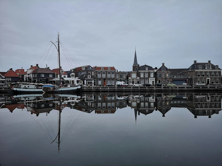 a large body of water filled with lots of boats, a picture, by Jan Tengnagel, pexels contest winner, delft, grey, next to the reflecting ocean, brown