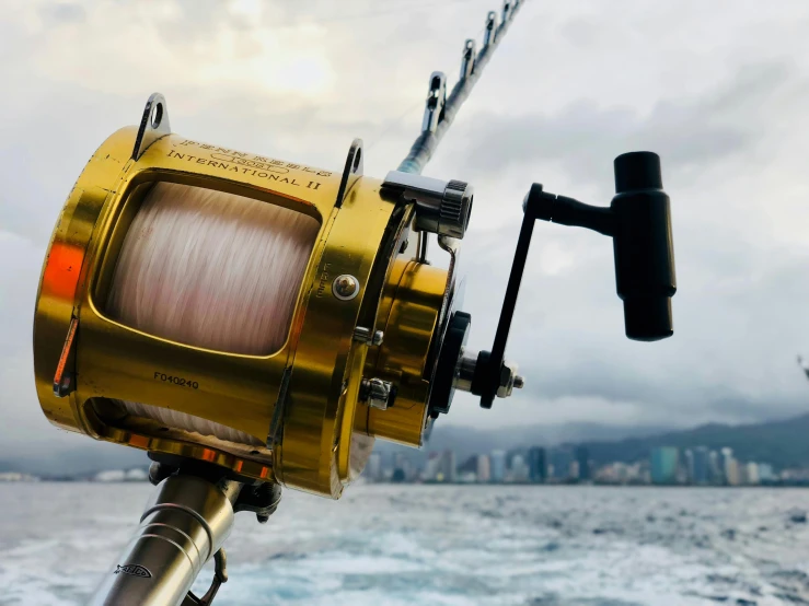 a close up of a fishing rod on a boat, pexels contest winner, photorealism, 💋 💄 👠 👗, the robot has a fishing rod, offshore winds, gold