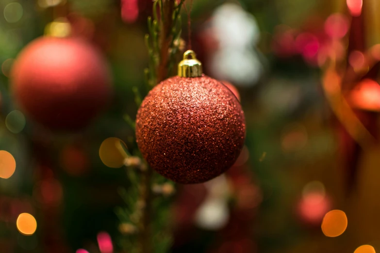 a close up of a christmas ornament on a tree, pexels, gradient brown to red, shot on sony a 7 iii, ball, thumbnail