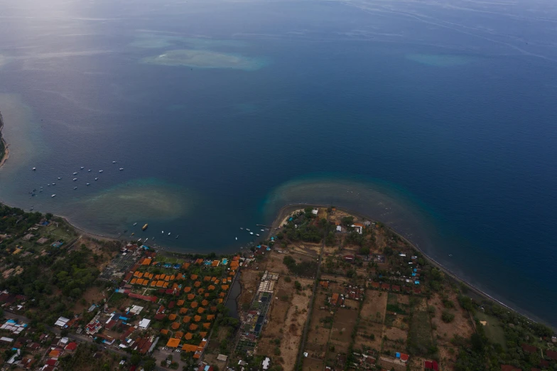 an aerial view of a large body of water, happening, bali, sea ground, fishing village, high res 8k