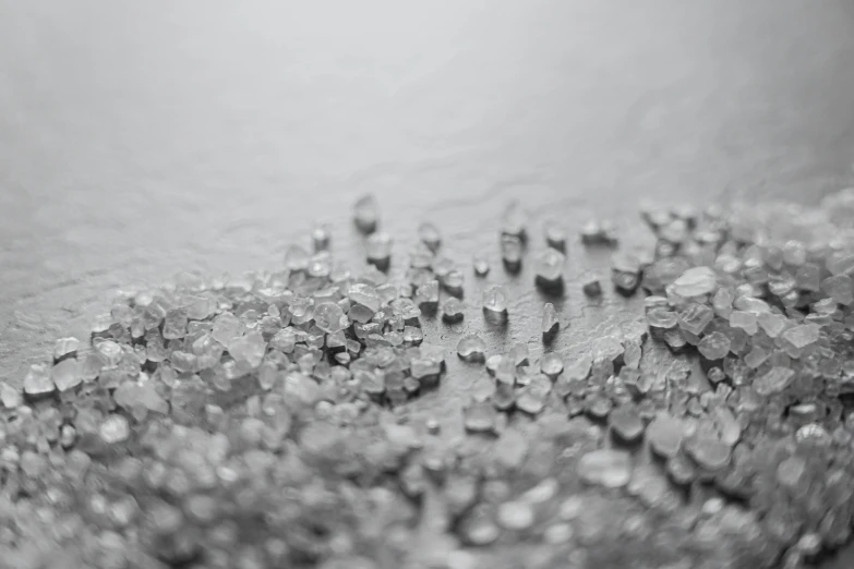 a pile of ice sitting on top of a table, a microscopic photo, unsplash, grey and silver, granular detail, close-up product photo, made of diamond