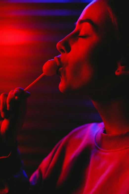 a woman singing into a microphone in a dark room, inspired by Nan Goldin, conceptual art, candy - coated, lollipop, profile image, reylo kissing