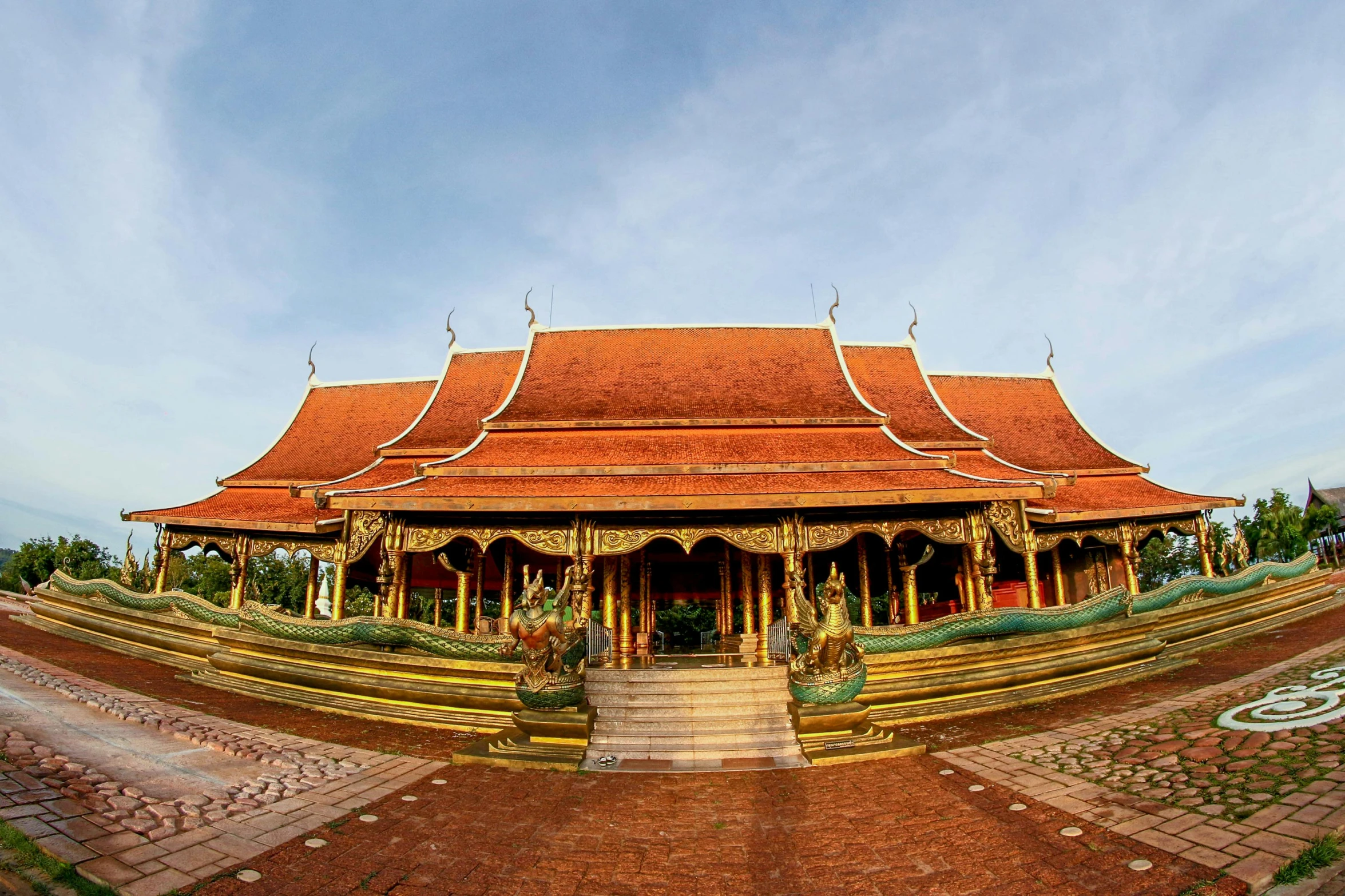 a large building sitting on top of a lush green field, sumatraism, thai temple, avatar image