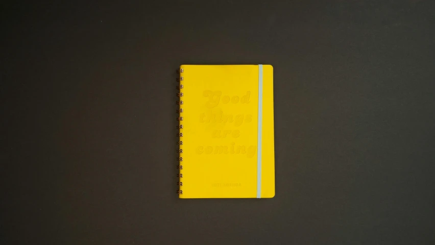 a yellow notebook sitting on top of a table