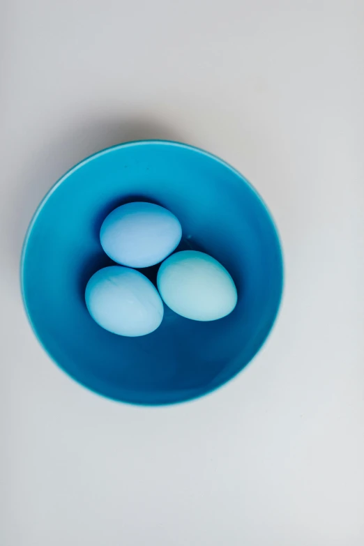 four eggs in a blue bowl on a white surface, by Jan Tengnagel, trending on unsplash, symbolism, gradient cyan, 15081959 21121991 01012000 4k, ilustration, soft blue light