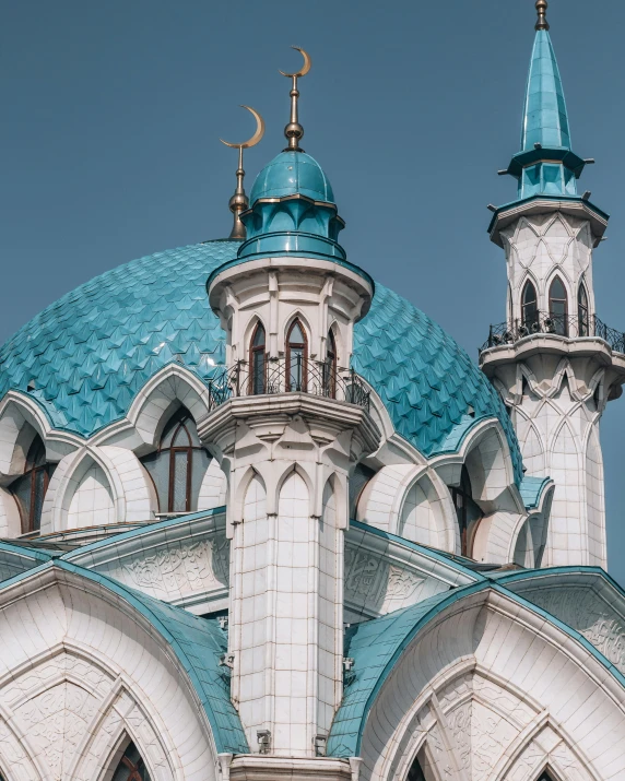 a blue and white building with a clock tower, a colorized photo, trending on unsplash, hurufiyya, with great domes and arches, ornate turban, gif, black and cyan color scheme