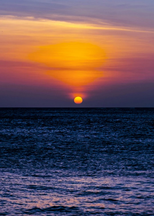 the sun is setting on the horizon of the ocean, by Jan Tengnagel, pexels contest winner, aruba, break of dawn on pluto, fine art print, bright yellow and red sun