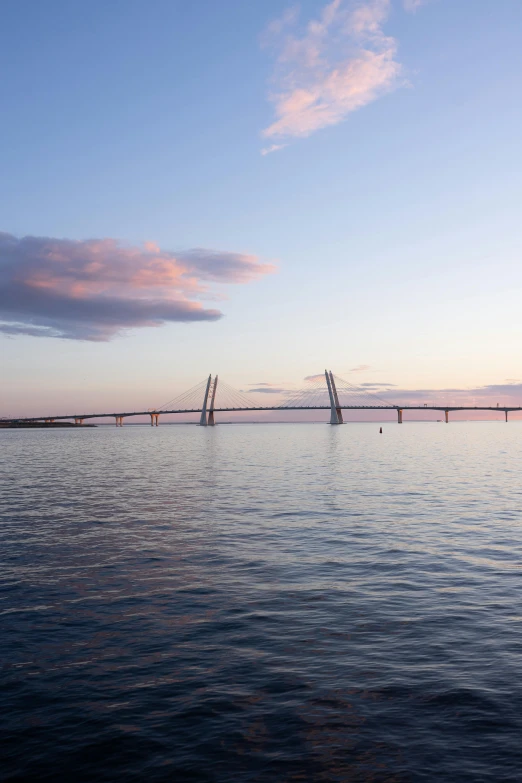 a large body of water with a bridge in the background, by Johan Lundbye, unsplash, hurufiyya, end of day, buttresses, archipelago, savannah