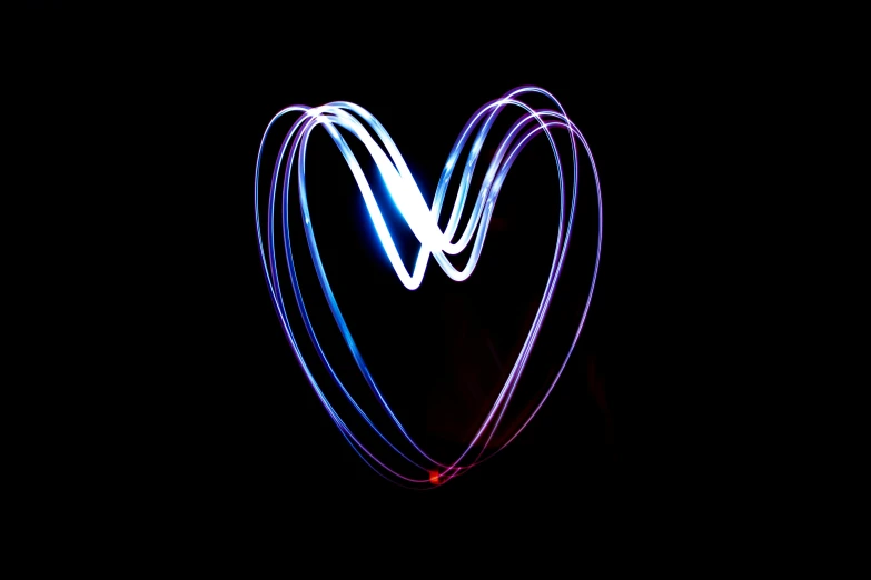 a heart shaped light painting in the dark, by Jan Rustem, pexels, love peace and unity, purple and blue neon, ( ( ( ( volumetric light ) ) ) ), red and blue black light