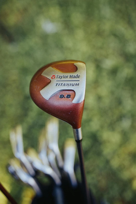 a close up of a golf club with a driver, an album cover, by David Simpson, titanium, rust, technologies, thumbnail