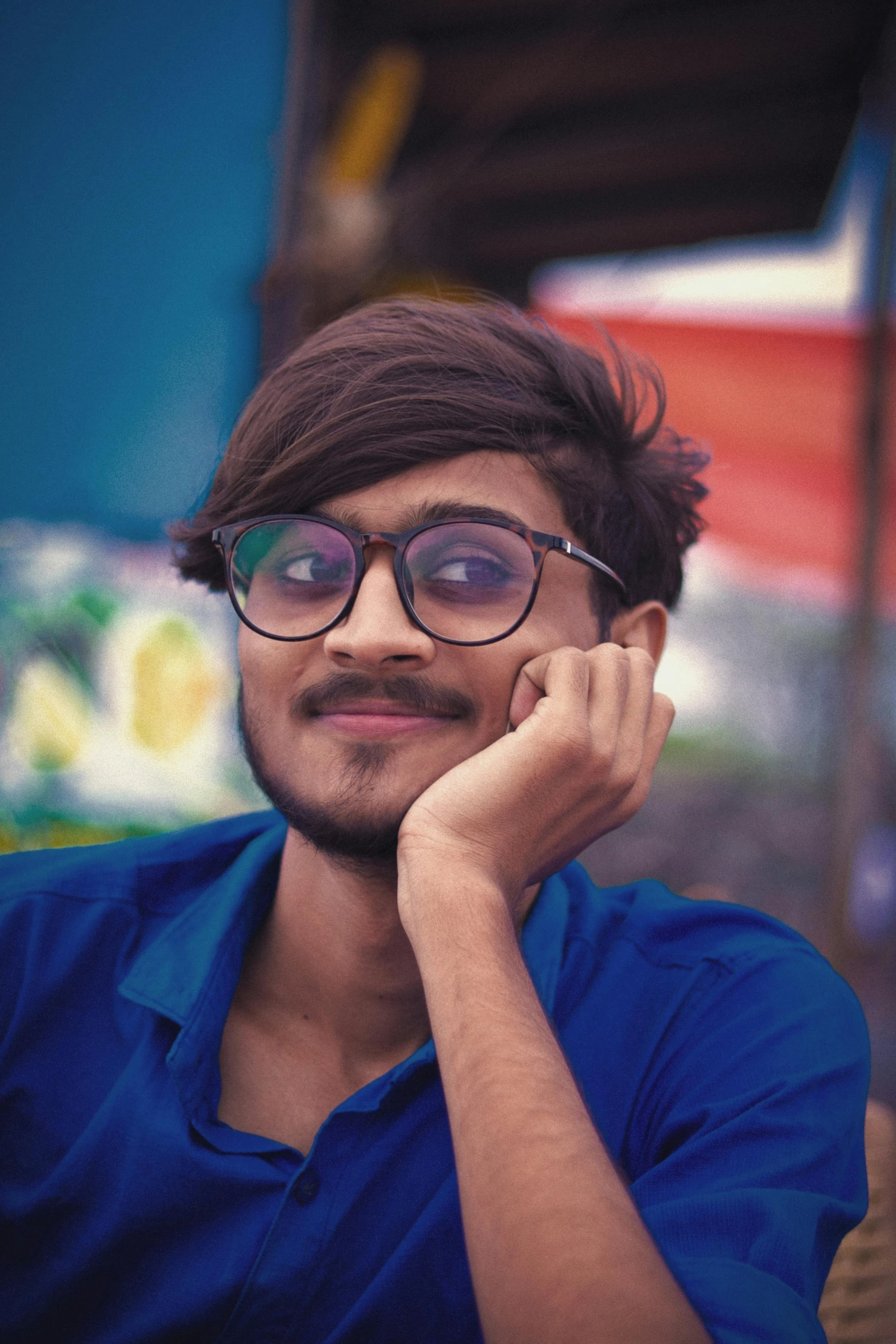 a man wearing glasses and a blue shirt, by Max Dauthendey, pexels contest winner, discord profile picture, assamese aesthetic, androgynous face, multicoloured