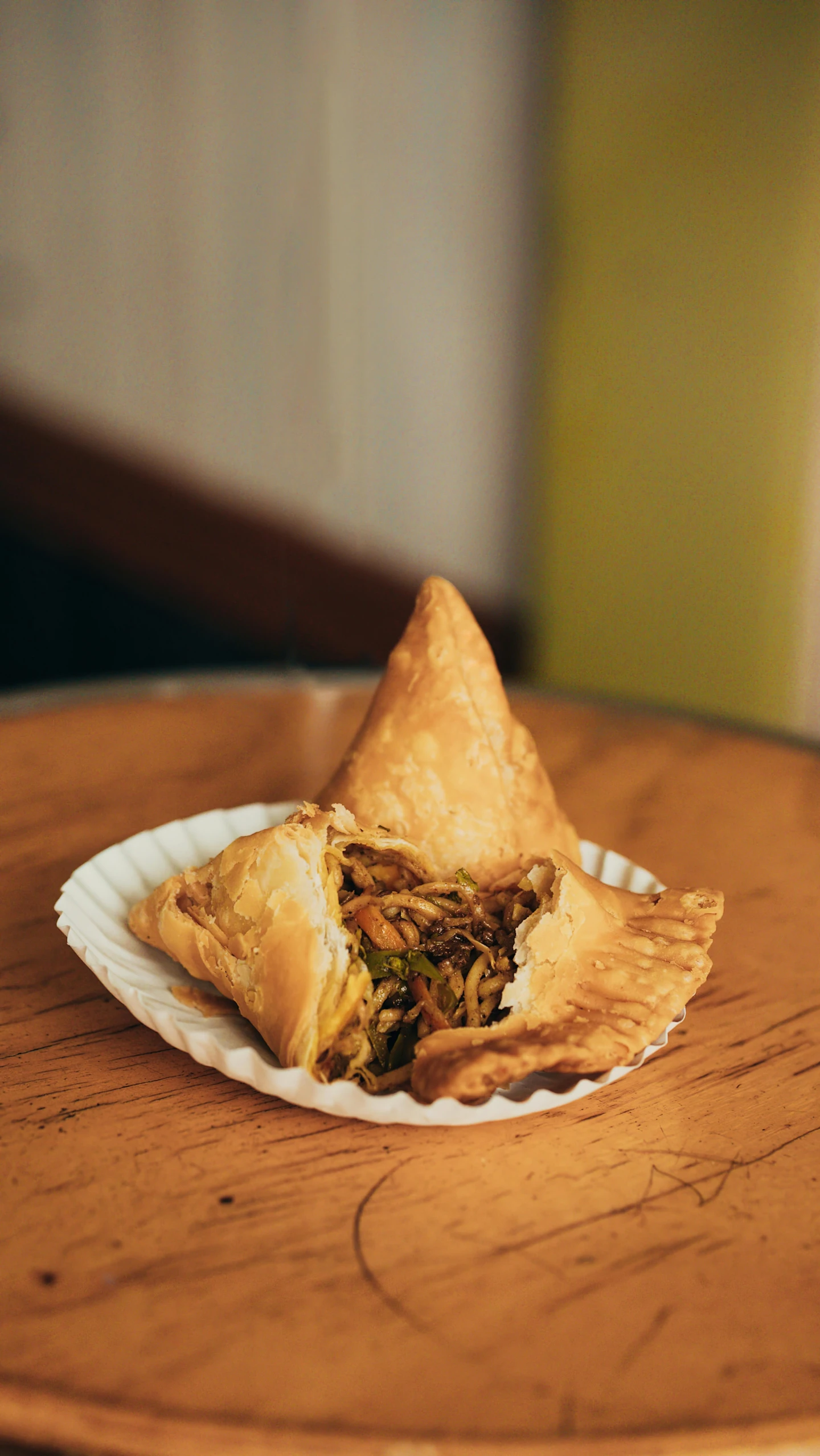 a piece of food sitting on top of a wooden table, hurufiyya, pointy conical hat, leftover meat pie, green, square