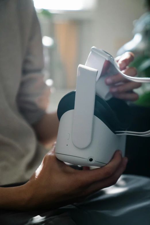 a close up of a person holding a nintendo wii controller, oculus quest 2, headphone stand, panoramic shot, white