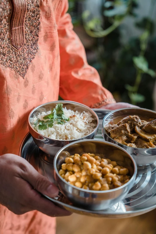 a close up of a person holding a plate of food, dau-al-set, nepal, teaser, elegantly, multi-part