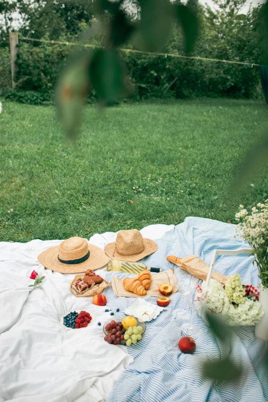 a picnic blanket sitting on top of a lush green field, a still life, pexels contest winner, romanticism, straw hat and overcoat, white tablecloth, couple, sydney park