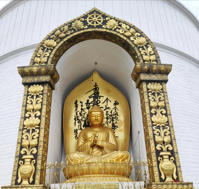 a golden buddha statue in front of a white building, 🦩🪐🐞👩🏻🦳, pavilion, finely detailed feature, the best ever