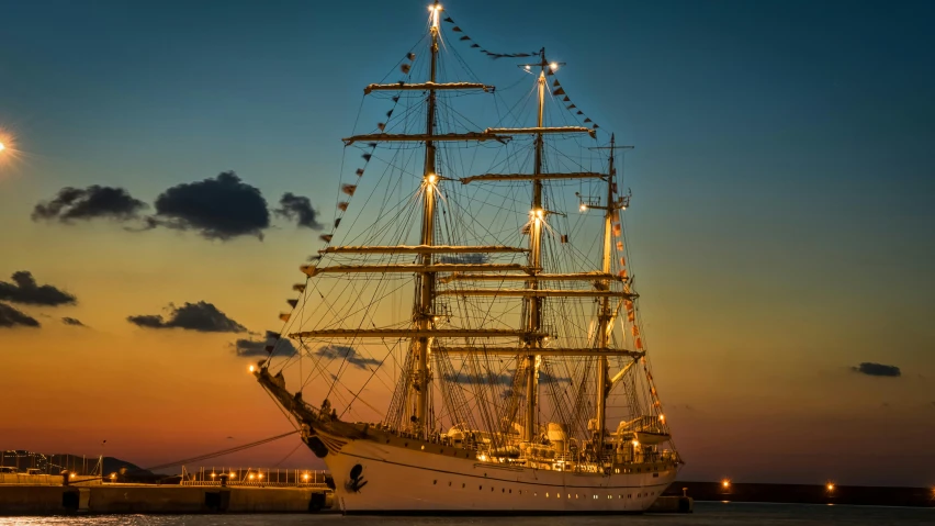 a tall ship sitting on top of a body of water, by Adam Marczyński, pexels contest winner, romanticism, evening lights, white beard, three masts, ready to eat