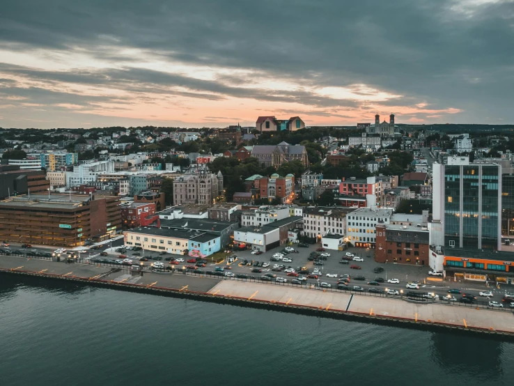 a large body of water next to a city, by Brian Snøddy, pexels contest winner, summer evening, drone footage, port, on a cloudy day