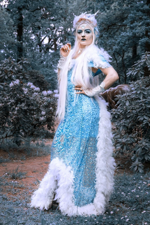 a woman in a blue dress posing for a picture, inspired by Louis Grell, reddit, ethereal white dripping tar, beautiful ancient frost witch, photograph taken in 2 0 2 0, full body! shot