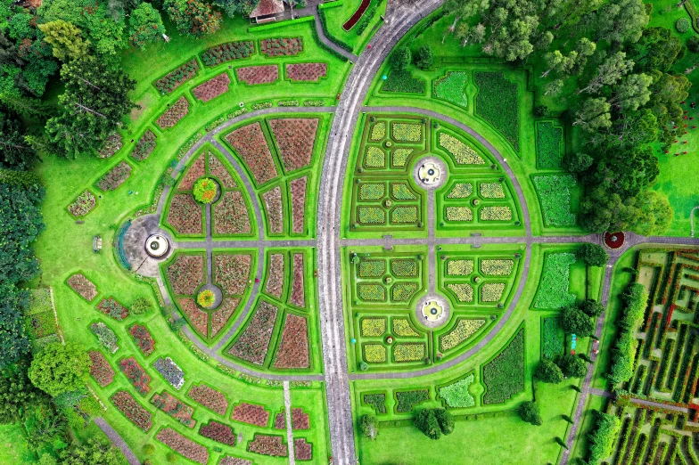 an aerial view of a maze in a park, inspired by Matthias Jung, pexels contest winner, land art, city of armenia quindio, city park with flowers, vibrant green, rounded architecture