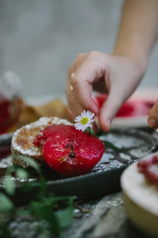 a close up of a plate of food with strawberries, holding a flower, digging, pancakes, crimson themed