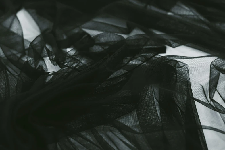 a pair of scissors sitting on top of a piece of cloth, a black and white photo, inspired by Anna Füssli, pexels contest winner, lyrical abstraction, in a black chiffon layered robe, unsplash transparent fractal, ruffled fabric, main colour - black