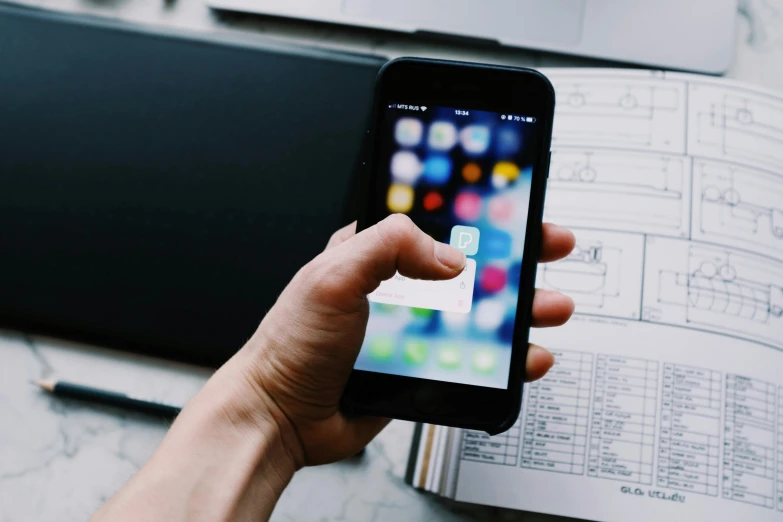 a close up of a person holding a cell phone, a picture, pexels contest winner, industrial design blueprint, square, programming, iphone