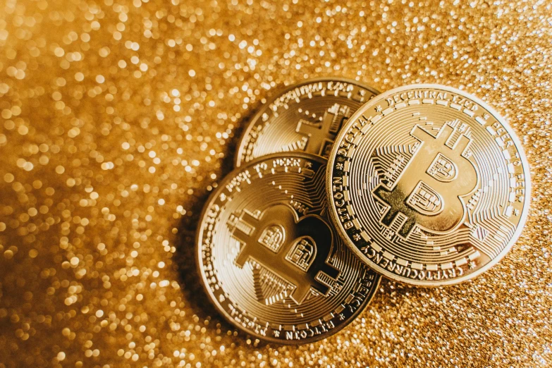 two bitcoins sitting on top of each other, by Julia Pishtar, trending on pexels, renaissance, glitter, relaxed. gold background, rule of three, group photo