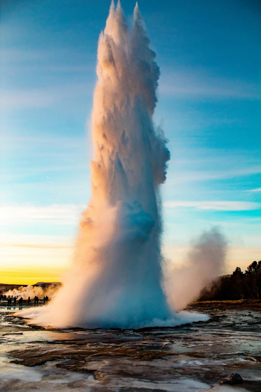 a large geyse spewing water into the air, giant towering pillars, 2019 trending photo, up-close, magic hour