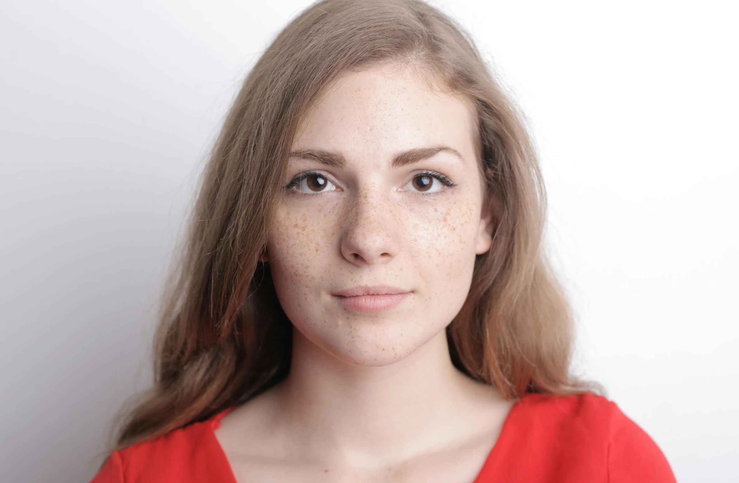 a close up of a woman with freckles on her face, passport photo, olya bossak, slightly red, ready to model
