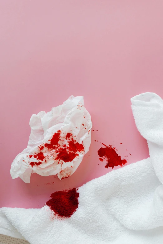 a piece of cake sitting on top of a white towel, by Julia Pishtar, happening, blood spray, wipe out, white and pink cloth, red color theme