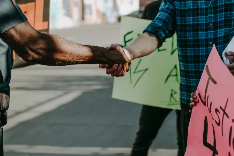 a group of people holding signs and shaking hands, pexels contest winner, renaissance, alexis franklin, neighborhood, coloured, two people