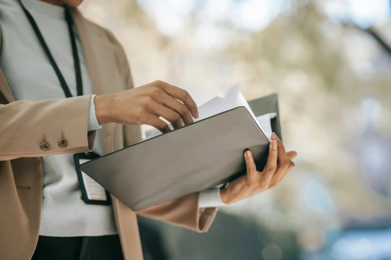 a close up of a person holding a folder, by Carey Morris, well - dressed, afternoon, rectangle, high quality upload