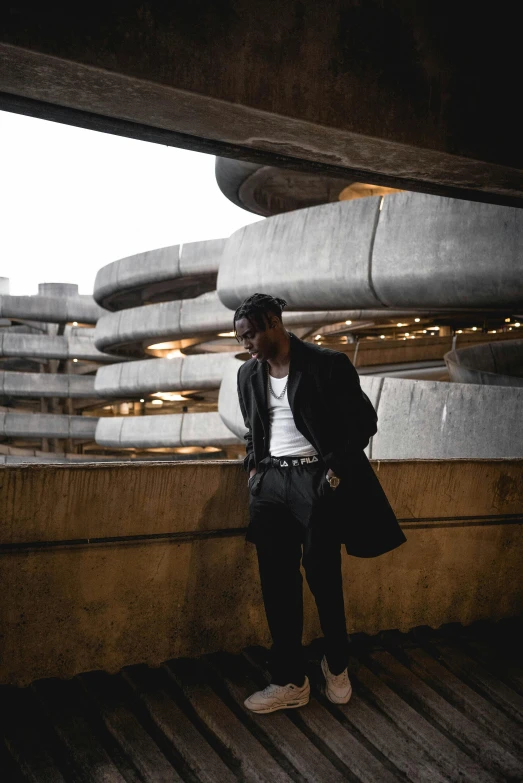 a man standing on top of a wooden floor, by Sam Charles, pexels contest winner, brutalism, black. airports, male model, : kendrick lamar, underground