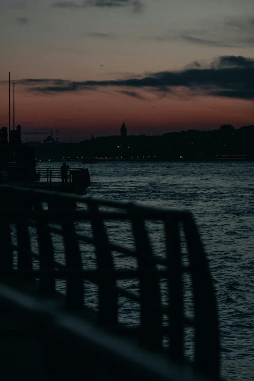 a bench sitting on top of a pier next to a body of water, inspired by Elsa Bleda, digital art, venice at dusk, album cover, istanbul, low quality photo