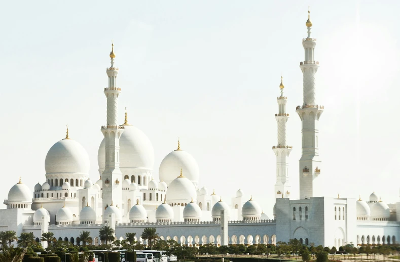 a large white building next to a body of water, by Sheikh Hamdullah, pexels contest winner, arabesque, norman foster, spires, plain background, aida muluneh
