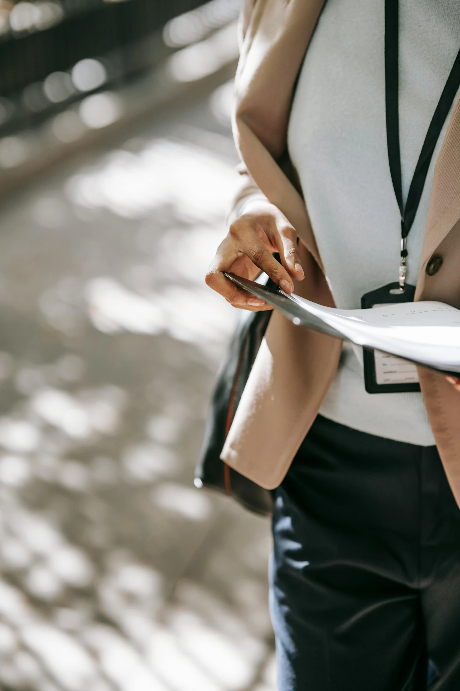 a close up of a person holding a piece of paper, pexels contest winner, walking to work, female investigator, holding a record, holding a tower shield