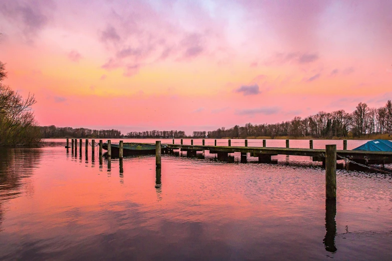 a dock that is next to a body of water, by Jan Tengnagel, pexels contest winner, romanticism, orange / pink sky, sunset panorama, lower saxony, soft lilac skies