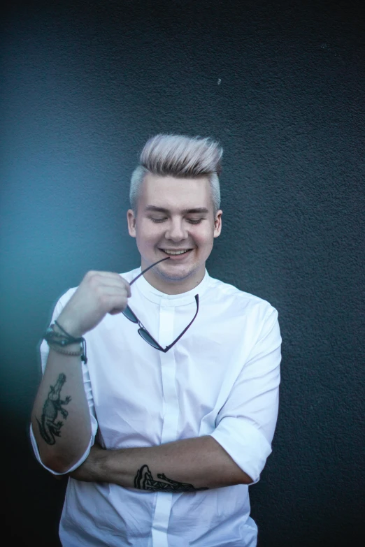 a man in a white shirt holding a pair of scissors, an album cover, inspired by Kristian Kreković, platinum hair, smileing nright, trending on spotify, profile picture 1024px