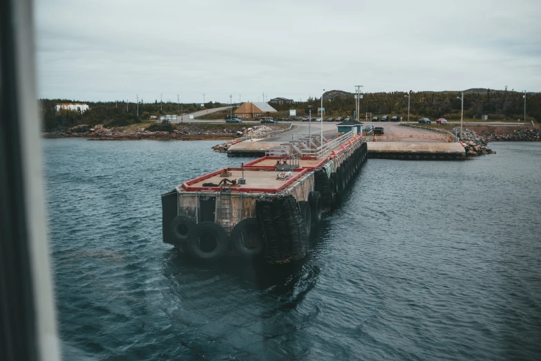 a pier in the middle of a body of water, an album cover, by Jesper Knudsen, pexels contest winner, hurufiyya, shipyard, partially operational, stålenhag, bulky build