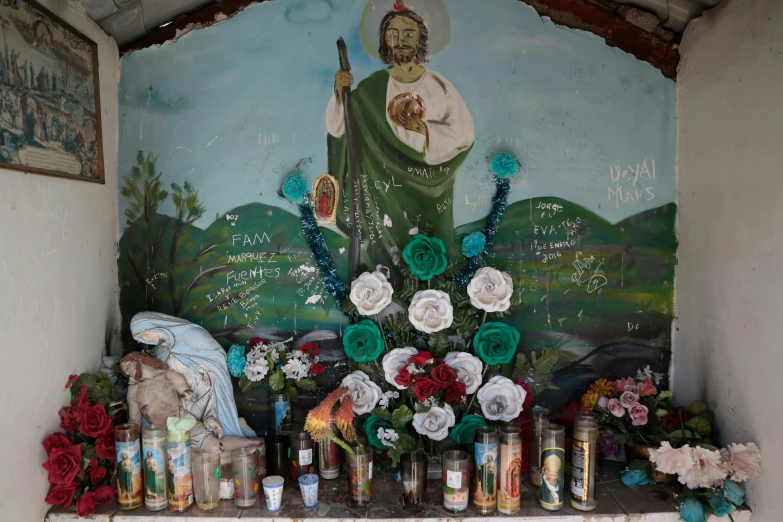 a shrine with candles and a painting on the wall, graffiti, in louisiana, slide show, mexican, roadside