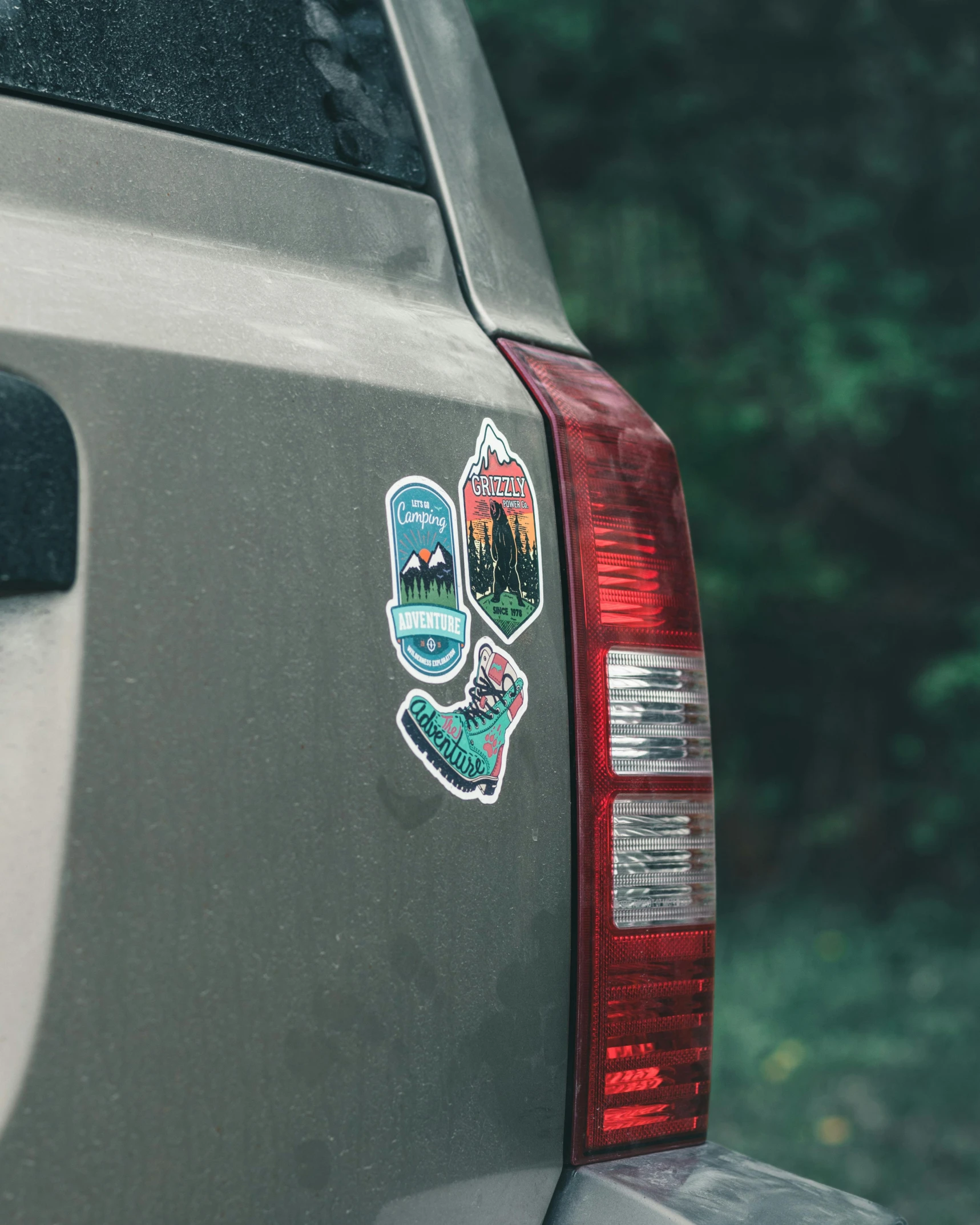 a close up of a car with stickers on it, by Carey Morris, pexels contest winner, rugged ranger, back view also, puffy sticker, slight overcast lighting