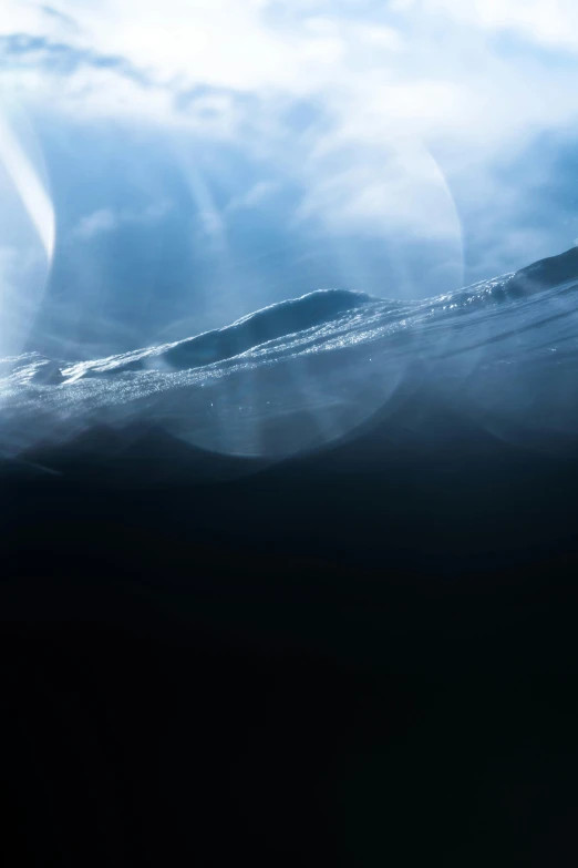 a man riding a surfboard on top of a wave, by Daniel Seghers, light and space, underwater view, icy, photographed for reuters, clouds on surface