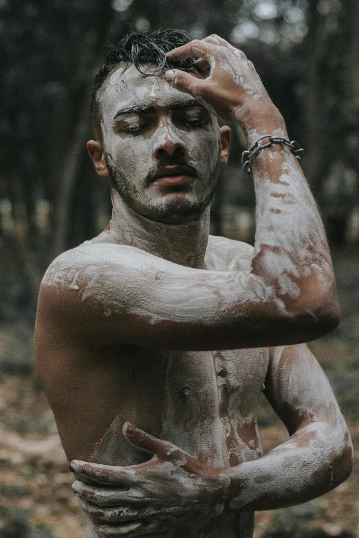 a man standing in the woods covered in mud, inspired by Elsa Bleda, pexels contest winner, renaissance, lean man with light tan skin, covered in white flour, gay, aboriginal